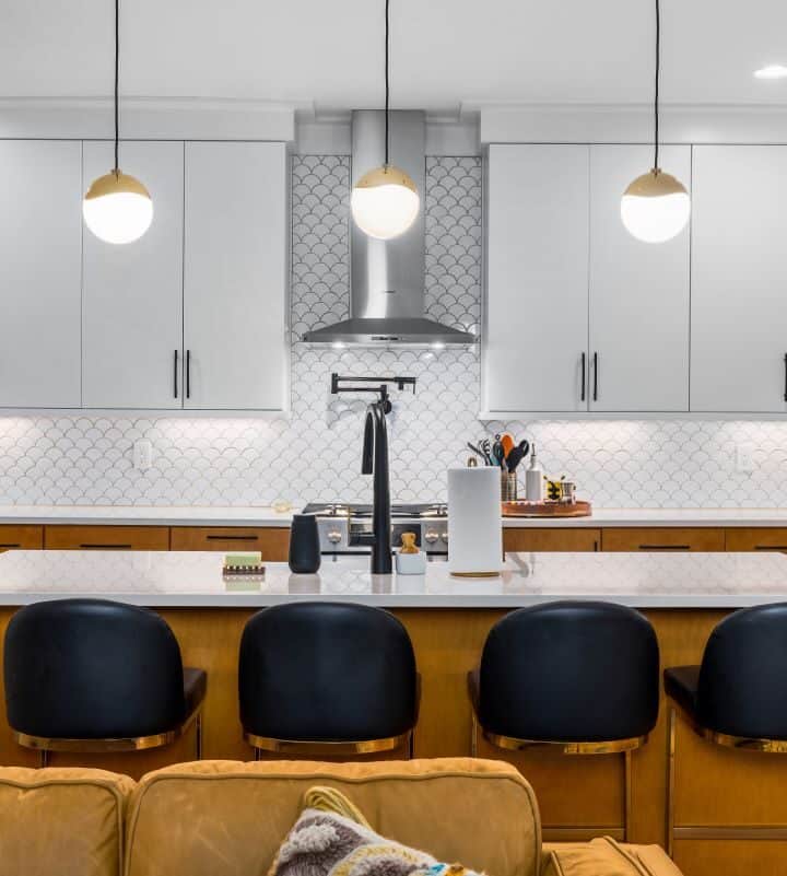 Modern kitchen with sleek white cabinets and a central island.