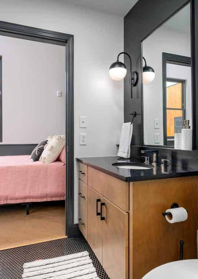 Modern Birmingham short-term rental bathroom with vanity and bedroom view.