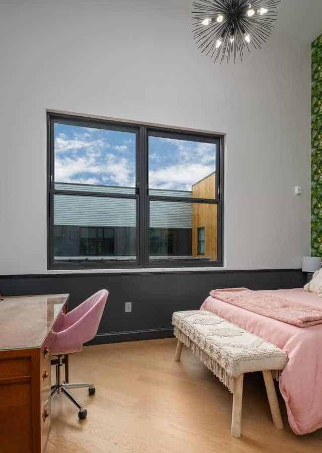 Comfortable Birmingham short-term rental bedroom with stylish decor and large window views.