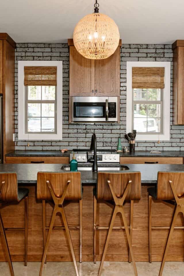 GHC 2.0 modern kitchen featuring brick wall and wooden accents.