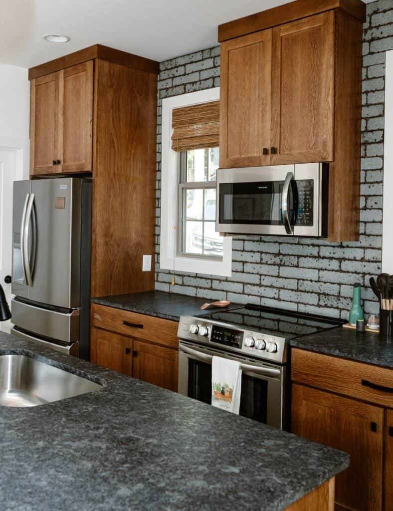 GHC 2.0 modern kitchen with wooden cabinets and stainless steel appliances.