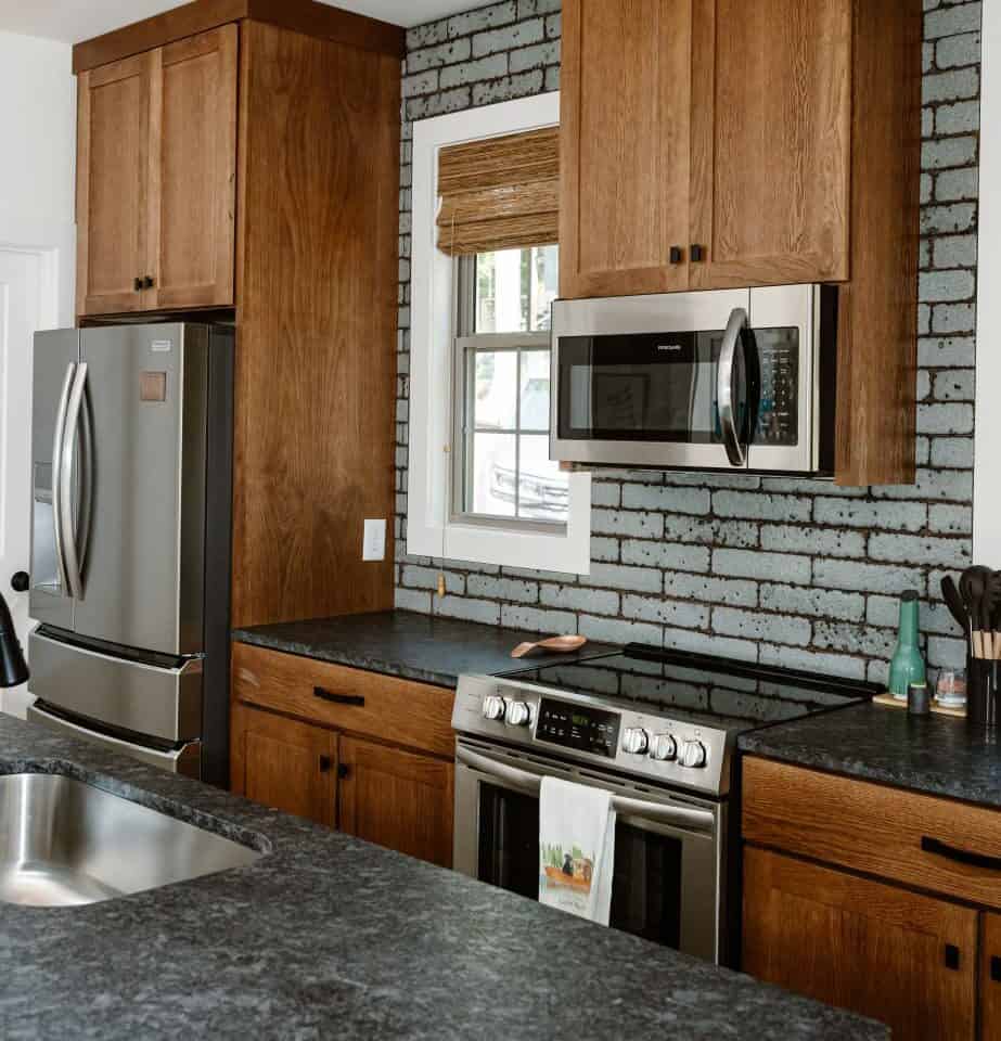 GHC 2.0 modern kitchen with wooden cabinets and stainless steel appliances.