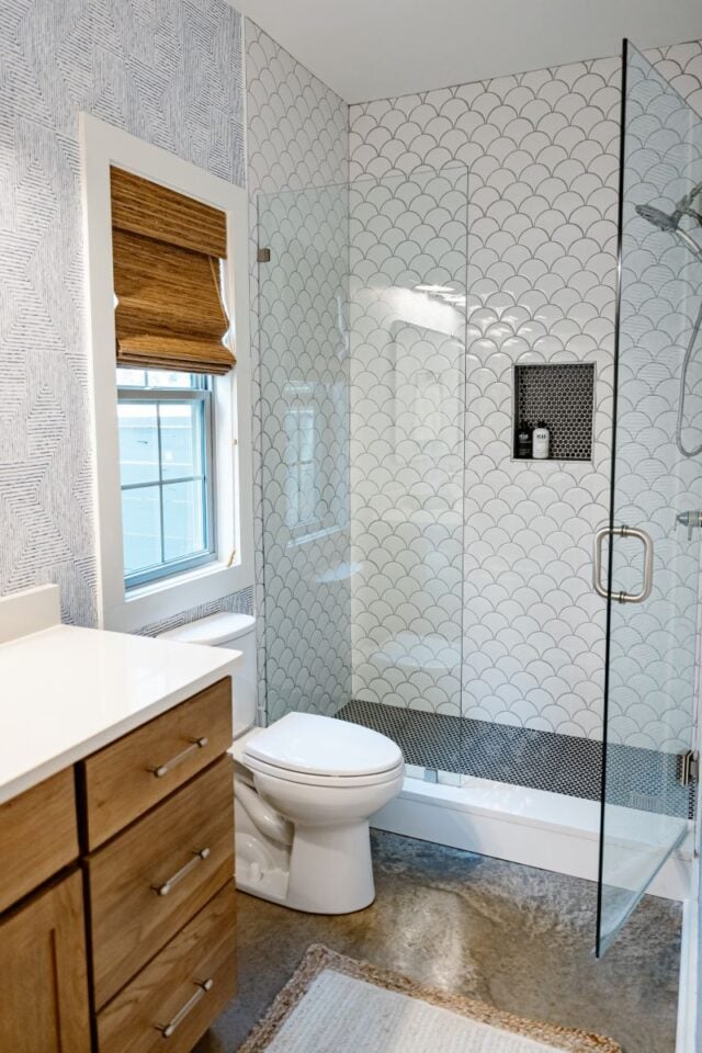 Spacious bathroom featuring a walk-in shower with glass enclosure and stylish tile design.