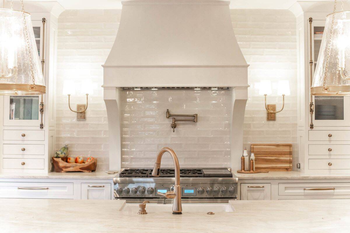 Elegant kitchen featuring a renovated cooking area with a stylish range hood and white cabinetry.