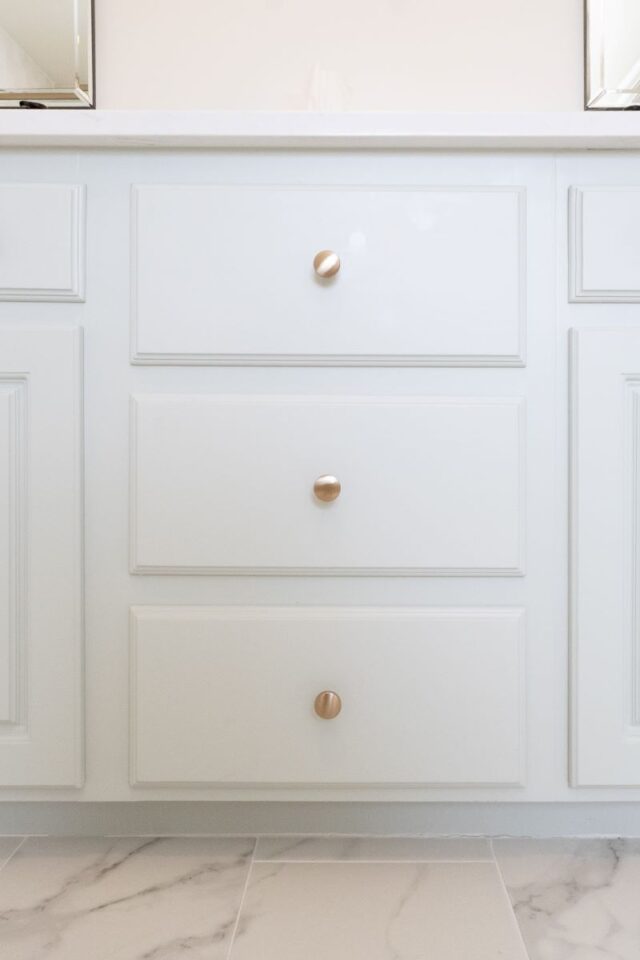 Highland Lakes bathroom vanity with white cabinets and gold knobs, part of a bathroom transformation.